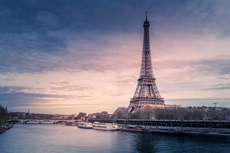 The Eiffel Tower beside the River Seine in Paris at dusk